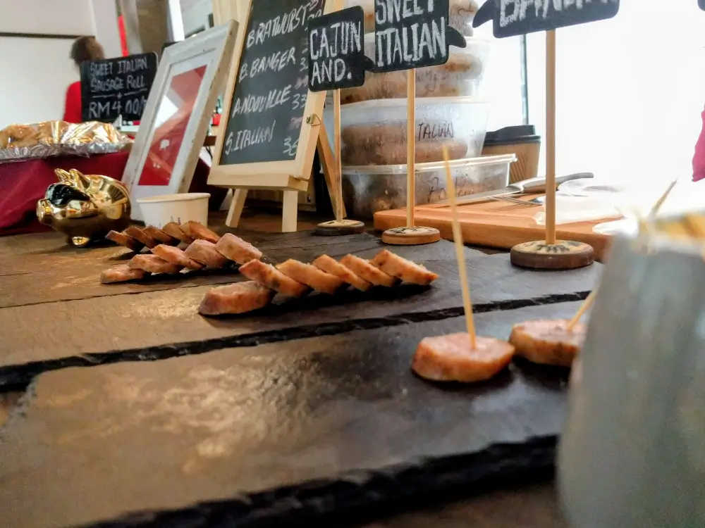 sliced artisanal handcrafted italian cajun andouille kielbasa british banger pork sausage on serving plate in side shot Abrahams Sausages  Meats Malaysia