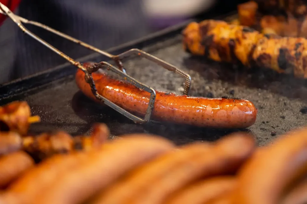 pexelsmateuszfeliksik189660413533561 | Abrahams Sausages Meats Malaysia chef grilling handcrafted artisanal pork sausage on grill in 45 degree side shot Abrahams Sausages Meats Malaysia